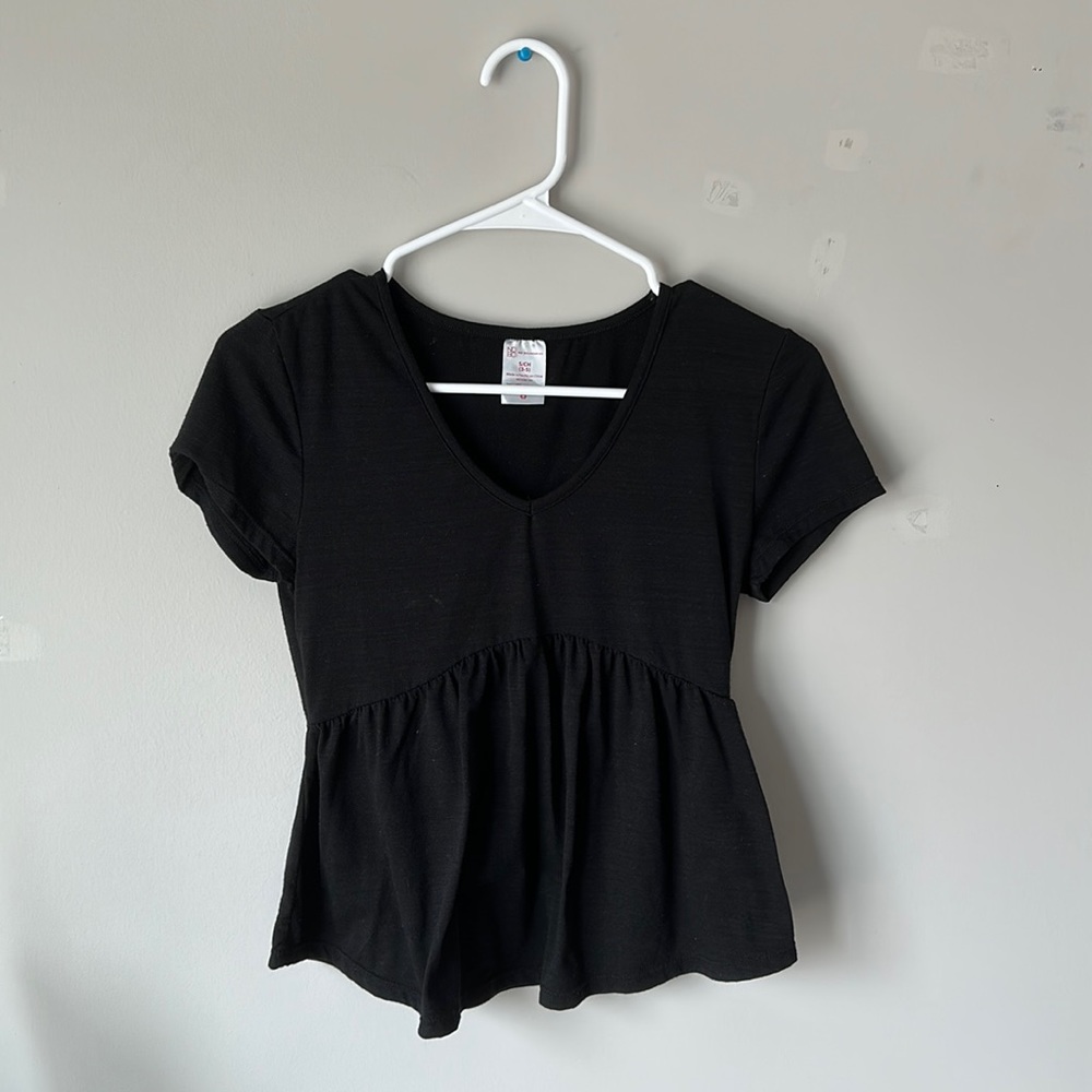 Black V-Neck No Boundaries Shirt with Ruffles at the bottom.